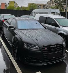 cars are parked on the side of the road in the rain