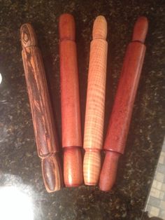 four wooden crochet hooks sitting on top of a counter