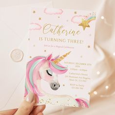 someone holding up a unicorn birthday party card