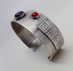 "Awesome sterling silver cuff bracelet. I formed the cuff from 18gage heavy sterling silver. A 8mm by 10 mm amethyst is at the center and 6mm garnet and 6mm citron gem stones at each side. The cuff is 3/4\"wide by 6 \" .All my jewelry come in a nice gift box." Modern Sterling Silver Cuff Jewelry, Modern Sterling Silver Cuff Bracelet For Anniversary, Modernist Cuff Jewelry For Gift, Silver Amethyst Gemstone Cuff Bracelet, Adjustable Sterling Silver Modernist Cuff Bracelet, Adjustable Sterling Silver Cuff Bracelet, Modernist Style, Adjustable Modernist Cuff Bracelet In Sterling Silver, Handmade Silver Amethyst Cuff Bracelet, Modern Silver Bangle With Gemstone