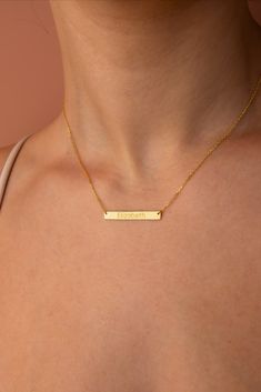 Elegant 14k solid gold bar necklace, handcrafted and personalized with a beautiful script name, epitomizing luxury, identity, and unparalleled craftsmanship. Minimalist Nameplate Necklace, Customized Minimalist Name Necklace, Simple Personalized Name Necklace For Anniversary, Gold Bar Necklace With Nameplate, Gold Nameplate Bar Necklace, Minimalist Name Bar Necklace For Mother's Day, Everyday Nameplate Bar Necklace With Custom Name, Minimalist Custom Name Bar Necklace For Anniversary, Gold Nameplate Bar Necklace For Mother's Day