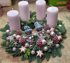 a wreath with candles and ornaments on the floor