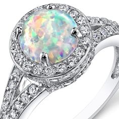 Add a pop of color with this Iridescent White Hue Opal Ring. Sparkly Sterling Silver makes this ultra luxurious without the high price. Style SR11168 Silver Halo Ring, Sterling Silver Opal Ring, Vintage Halo, Silver Opal Ring, White Opal Ring, Fire Opal Ring, Gem Stones, Fine Jewels, Opal Ring