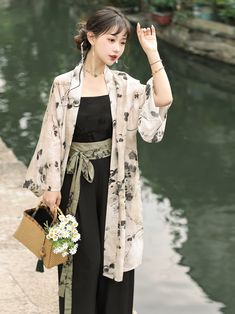 Reminiscehnt of classic Chinese ink paintings, this Song Dynasty inspired set is light and breezy - perfect for warmer weather. A pristine white Beizi 褙子 (long jacket) adorned with delicate black watercolor flowers. This jacket is light and airy, made of a breathable linen blend, and perfect for layering. Pair with the matching Diaodai 吊带 (tank top undergarment) and Song Ku 宋裤 (Song Dynasty trousers) both in a deep ink black. The Song Ku feature the traditional wide-leg design with triangular pl Elegant White Spring Kimono, White Kimono For Tea Ceremony In Spring, White Kimono For Spring Tea Ceremony, Hanfu Men, Modern Hanfu, Black Watercolor, Ink Paintings, Chinese Ink, Song Dynasty