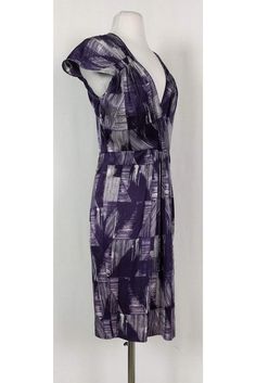 This pretty dress has a fun abstract print in a chic purple and white color. Cap sleeves, a plunging neckline and pleats along the waist all elevate this basic dress from Poleci. It can be dressed up or down for any occasion. Size 4 91% silk, 9% lycra V-neck Cap sleeves Side zipper Unlined Abstract print Bust 34.5" Waist 30" Shoulder to hem 39" Elegant V-neck Maxi Dress With Abstract Print, Printed V-neck Midi Dress For Evening, Elegant Maxi Dress With Abstract Print And V-neck, Formal Printed V-neck Dress, Purple V-neck Lined Dress, Chic Lined Purple Dress, Chic Purple Lined Dress, Fitted Purple Printed Midi Dress, Elegant V-neck Midi Dress With Abstract Print