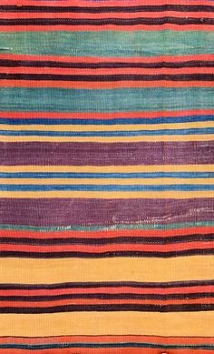 an old rug with multicolored stripes on it