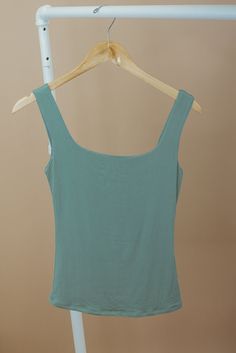 The Double Layered Reg Length Tank is a must-have for a casual summer wardrobe, offering the best basics with its double-layered design that adds a touch of uniqueness to a cute and solid shirt. This stylish and lightweight tank effortlessly embodies a summer aesthetic. Double Layered Tee Fixed straps Premium ribbed knit fabrication Fit: Fitted; Generous stretch Fabric: 92% Nylon 8% Spandex Model Specs: Emily + Karli are wearing a size small in the photo.How will this item fit you? Check out our Casual Green Solid Color Tank Top, Summer Beach Plain Tops, Casual Plain Tank Top For Summer, Plain Green Top For Summer, Summer Cotton Tank Top In Solid Color, Cotton Solid Color Tank Top For Summer, Solid Color Cotton Tank Top For Summer, Solid Color Summer Tops For Day Out, Summer Cotton Solid Color Tank Top