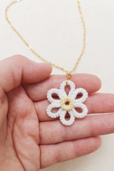 White daisy pendant, cute daisy necklace, white flower jewellery, floral necklace, tatting lace, handmade cotton lace, anniversary gift Cute handmade lace daisy necklace with a retro aesthetic. Pictured in a classic white daisy colourway, you can order this necklace in up to 12 colourways to create your own colourful daisy... This necklace has been handmade by me using the lace making craft of tatting, made with bamboo cotton yarn and finished with 24kt gold plated chain. The daisy measures appr Handmade White Flower Shaped Necklace, White Dainty Flower Pendant Necklace, Delicate White Flower Pendant Necklace, White Pendant Necklace With Flower Charm, Dainty White Flower Pendant Necklace, White Flower-shaped Delicate Necklace, Delicate White Flower Necklace, Dainty White Necklace With Flower Charm, White Flower Shaped Necklace With Flower Charm