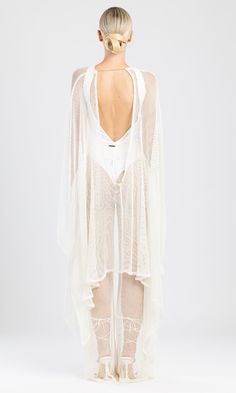 With its open back and decorative golden chain, our Tiye beach cover up has a unique and minimal design that ensures an elegant and classy look.This beach cover-up is made of shiny metallic mesh. It can be worn over swimwear or paired with matching Nety trousers. It's knee-length makes it ideal for summer nights out or beach days. This cover up set, with its feminine and flirty design, is the perfect choice for a sunny vacation in the sun. One size fits all. We are conscious luxury. Read more in Elegant Summer Festival Cover-up, Backless Beachwear Cover-up For Beach Party, Long Sheer Cover-up For Party, Elegant White Cover-up For Festival, Elegant Sheer Party Cover-up, Elegant White Party Cover-up, Luxury Flowy Cover-up For Women, Summer Evening Beachwear Cover-up, Elegant Sheer Cover-up For Beach