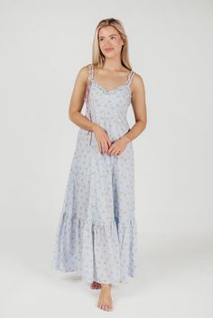 Simple but absolutely charming, the Penelope Maxi Dress is just the ticket for your next summer event. From its delicate ruffled details to its in-seam pockets and flounced skirt, the Penelope is all cottagecore elegance. Dressed up with heels or dressed down with slides or mules, this dress promises season after season of beautiful wear. Available in two colorways. FIT: Runs true to size. MATERIAL: Cotton. GARMENT DETAILS: Lightweight floral maxi dress with V-neckline, ruffled double straps, and a cinched waist. Features full skirt with ruffled hem, dual in-seam pockets, and a smocked back panel. SIZE GUIDE: XS (0-2) / S (2-4) / M (6-8) / L (10-12) / XL (14-16) MODEL DETAILS: MISSES Mackenzie - Size S Heather - Size S Bust 34" 34" Waist 27.5" 27.5" Hips 40.5" 37.5" Height 5'7" 5'7" Spring Sundress With Ruffled Straps For Picnic, Spring Maxi Dress With Ruched Ruffled Straps, Spring Maxi Dress With Ruched Details And Ruffled Straps, Spring Ruffle Dress With Ruffled Straps For Day Out, Spring Dresses With Ruffled Straps, Blue Cotton Dress With Ruffled Skirt, Spring Vacation Ruffle Dress With Ruffled Straps, Spring Ruffle Dress With Smocked Back, Spring Tiered Lined Maxi Dress