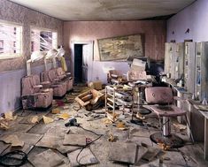 an old room filled with furniture and broken windows