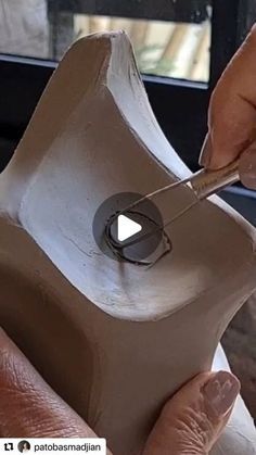 a person is making something out of clay