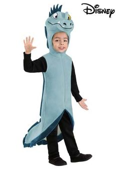 a little boy in a blue costume standing up with his hand out to the side