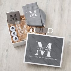 an open box containing personal items for grooms and their wedding day, with the letter m on it