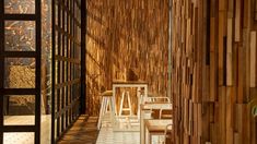 an empty restaurant with wooden walls and chairs