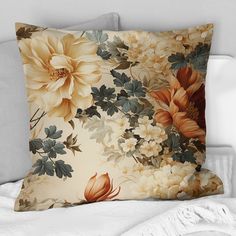 a pillow with flowers on it sitting on a bed