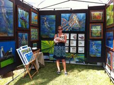 a woman standing in front of an art display