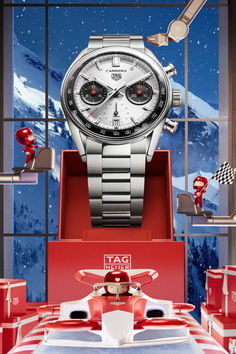 a watch is displayed in front of a window with red and white boxes on it