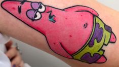 a pink cartoon character on the arm