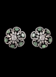 "This piece is quite unique studded with CZ crystal gemstones. Traditional Indian bridal earrings made with hammered metal and plated with silver. Gorgeous floral design makes this piece a stunner. Clear CZ stone setting further adorns this earring jewelry.  Luxurious green stone all over this bridal jewelry adds color to this stud. Green Onyx crystal makes this stud earrings one of a kind. Perfect to enhance any of your attires for a special day.  Approximate earrings 3.5\" Details: Handcrafted Silver Earrings With Stones For Formal Occasions, Formal Silver Earrings With Stones, Elegant Silver Earrings With Stones, Silver Jeweled Crystal Earrings With Cubic Zirconia, Elegant Cubic Zirconia Earrings With Stone Setting, Silver Crystal Earrings With Stones, Silver Jeweled Cubic Zirconia Earrings, Silver Earrings With Cubic Zirconia Stones, Diamond Jeweled Earrings For Anniversary