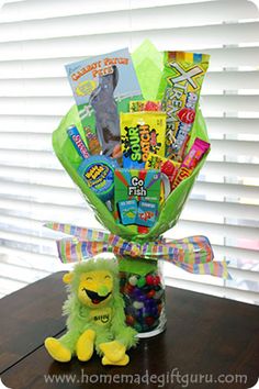 a stuffed animal sitting next to a vase filled with candy