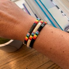 Skies are blue! These sweet rainbow bracelets for women will bring a much-needed smile after the rain. Perfect for women who love the joy of rainbows or as a memorial of a special loved one. Look — the clouds are parting!+ glass tile beads + two stretch cords+ finished with gold-plated beads (lead-free and nickel-free)+ 7" (fit most adult wrists)+ packaged in a clear resealing bag for storage and gift givingAVAILABLE STYLES+ Ivory/Rainbow+ Black/RainbowBUY MORE, SAVE MORE!Buy 2 or 3 and save! Ne Colorful Adjustable Beaded Bangle, Colorful Adjustable Beaded Bangle Bracelet, Casual Rainbow Beaded Bracelets With Sliding Knot, Adjustable Rainbow Friendship Bracelets With Colorful Beads, Adjustable Rainbow Friendship Bracelet With Colorful Beads, Multicolor Resizable Braided Bracelets For Everyday, Resizable Multicolor Braided Bracelets For Everyday, Adjustable Rainbow Friendship Bracelets With Letter Beads, Adjustable Rainbow Friendship Bracelets For Everyday