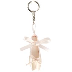 a pair of ballet shoes is hanging from a keychain on a white background