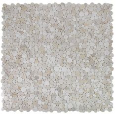 a white and beige rug with pebbles on it