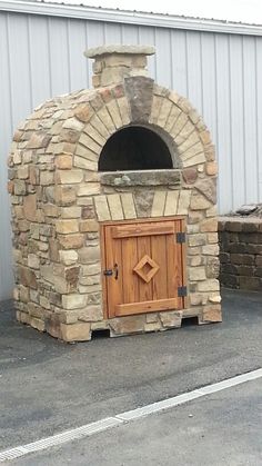 an outdoor brick oven with a wooden door