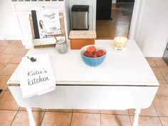 a bowl of strawberries sitting on top of a kitchen counter next to a sign