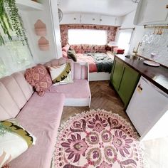 a living room filled with furniture next to a kitchen and dining area in a mobile home