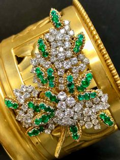 French made brooch done in 18K yellow gold and platinum circa 1960's set with approximately 8cttw in larger G-H color Vs1-2 clarity rounds diamonds as well as approximately 5cttw in vibrant green emeralds. All hallmarks and export marks are intact. Dimensions/Weight 2" wide by 2.25" long. Weighs 23dwt.  Condition Two emeralds have minor chips, but nothing obvious. May we all age as well. Luxury Green Brooch For Formal Occasions, Vintage Green Diamond Brooches, Luxury Green Brooch For Anniversary, Luxury Green Brooches For Anniversary, Fine Jewelry Green Brooches For Anniversary, Fine Jewelry Green Brooch For Anniversary, Green Fine Jewelry Brooch For Anniversary, Leaf Brooch, Fancy Jewelry