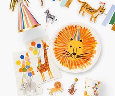 children's birthday party supplies including paper plates, balloons and giraffes