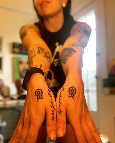 a woman with tattoos on her arms and hands