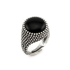 This shield ring, crafted from sterling silver, is adorned with a striking black onyx that exudes a sophisticated allure. The combination of black onyx with silver creates a perfect balance between bold elegance and timeless style. The minimalist and refined design makes this ring suitable for any occasion, whether it's a day at the office, an elegant evening, or a casual get-together with friends. The black onyx, with its deep, rich color, captures the light and draws the eye, adding a touch of Timeless Silver Cabochon Rings, Timeless Adjustable Black Jewelry, Silver Onyx Cabochon Rings, Silver Onyx Rings With Black Enamel, Black Sterling Silver Cabochon Ring, Black Cabochon Sterling Silver Ring, Nickel-free Black Open Ring Jewelry, Nickel-free Black Open Ring, Black Sterling Silver Metal Ring