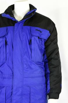 "Royal blue with contrasting black on the shoulders, sleeves, & zipper pulls. Polyfill. Elasticized cuffs. 6 outside front zip pockets. Inside waist adjuster . Great pre-owned vintage, however, the coat is missing its zip-off hood. Estimated Modern Size: XL *Vintage clothing runs significantly smaller than modern clothing. We offer a comprehensive size estimation in accordance with modern-day size charts. Vintage Tag Size: XL Material: nylon Lining: synthetic Closure: zip, velcro, & snap Winter Blue Windbreaker With Zipper Closure, Blue Windbreaker With Zipper Closure For Outdoor, Blue Windbreaker With Zipper For Outdoor, Blue Windbreaker With Pockets For Cold Weather, Blue Long Sleeve Windbreaker For Winter Sports, Blue Windbreaker With Ribbed Cuffs For Winter, Blue Outerwear With Pockets For Winter Sports, Weatherproof Blue Outerwear For Streetwear, Blue Sports Outerwear With Zipper Closure