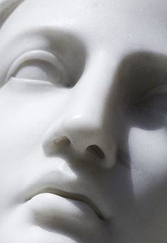 a white mannequin's head with its eyes closed