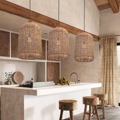 a kitchen with wooden stools and hanging lights