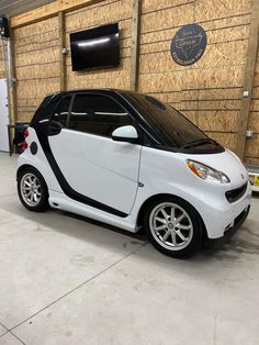 a smart car is parked in a garage