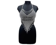 Chainmail Top Aluminum Butted Ring Chain Design Body Jewelry Stylish Medieval Halter Top Ren Faire Dress, Rave Outfit, Product Details Material : Aluminum Ring Diameter : 09mm Ring Type : Butted Rings Color : Silver Finish : Anodized Closure : Lobster back closure We have all sizes available. Kindly Check your desired size and write a note while booking your order. You can also share your costume size All Size And All Gauge are available This excellent chainmail is 100% Hand Crafted. This chainm Dress Rave Outfit, Ren Faire Dress, Faire Dress, Chainmail Clothing, Chainmail Top, Woven Ring, Outfit Halloween, Rave Outfit, Ring Chain