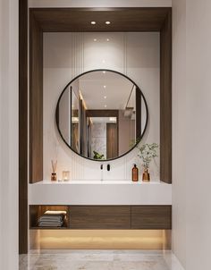 a bathroom with a large round mirror above the sink