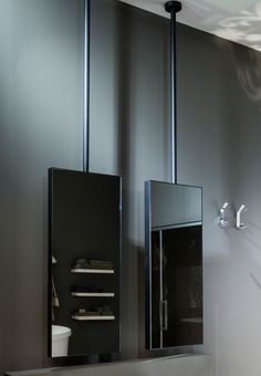 a modern bathroom with stainless steel fixtures and gray walls