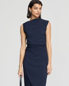 The elevated midi dress is a wardrobe must-have — Manon exudes effortless polish with its asymmetric neckline, ruched sides, and wrap front. We love to style it with a sleek pair of heeled boots for a desk-to-drinks look. See below for our general Size Guide and available measurements Made of 73% rayon, 23% nylon, and 4% spandex Machine wash cold and lay flat to dry Chic Ruched Dress With Asymmetrical Neckline, Blue Asymmetrical Neckline Dress For Work, Chic Blue Midi Dress With Asymmetrical Neckline, Blue Surplice Neckline Work Dress, Navy Dress Outfit, Chic Asymmetrical Ruched Dress, Midi Length, Navy Dress Outfits, Navy Wrap Dress, Modern Clothing