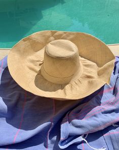 "Natural beige palm straw hat called the 'Poppadom!' A flexible wide brim hat you can switch into any shape - so it's lots of fun and can be styled for any occasion. Easy to wear, not hot and easy shape to your liking. Soft, natural material made from palm straw. Returns back to it's original shape. This hat is handmade, easy to wear, great for travel and a best seller! 🌀Flat top crown 🌀Flexible brim to adjust to your style 🌀Casual sun protection hat great for walking or gardening 🌀Lightweig Luxury Casual Sun Hat With Flat Crown, Luxury Natural Color Sun Hat With Flat Crown, Luxury Fitted Sun Hat For Vacation, Cheap Yellow Casual Sun Hat, Luxury Bohemian Sun Hat For The Beach, Luxury Flat Crown Sun Hat For Vacation, Luxury Vacation Straw Hat With Flat Crown, Luxury Natural Color Sun Hat For Beach, Cheap Yellow Sun Hat For Spring