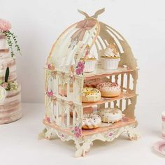 there are cupcakes and cakes in the miniature birdcage