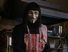 a person wearing a mask in a kitchen