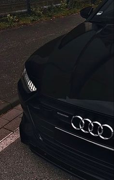 an audi car is parked on the side of the road