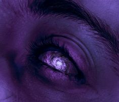 an image of the iris of a person's eye with purple lighting on it