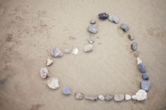 heart made out of rocks on the beach