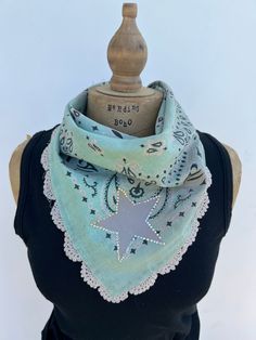 Looking for a unique accessory? This one of a kind  bandana is embellished with a painted star outlined in crystal bling with a lace embellished edge.  This is the perfect accessory to top off your outfit.  This embellished bandana has been tea stained and tattered slightly to give it a soft vintage vibe.  Have fun with it as it is the perfect accessory to most any boho, cowgirl chic or festival outfit.  All fabrics are sanitized before assembly. Thank you for visiting my site Bohemian Cotton Bandana As Gift, Bohemian Cotton Bandana Gift, Blue Bohemian Bandana For Summer, Spring Festival Bandana Scarf, Adjustable Vintage Style Bandana, Handmade Cotton Summer Bandana, Handmade Cotton Bandana For Summer, Hippie Cotton Bandana For Festivals, Handmade Adjustable Cotton Bandana